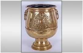 Dutch Brass Footed Planter Of Unusual Form, with brass embossed lion ring handles to the sides, the
