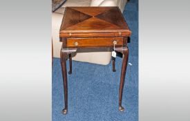 An Edwardian Mahogany Envelope Card Table with a swivel action & green fabric interior. Coin carved