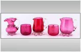 Five Small Pieces Of Cranberry Coloured Glass, including 2 cups & 3 jugs.