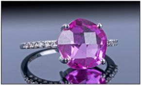 18ct White Gold Set Round Pink Sapphire And Diamond Ring The Pink Sapphire of excellent colour with