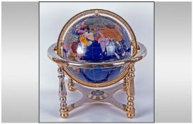 World Gem Globe, tilt and swivel, set in four legged gilt metal stand