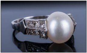 Ladies Pearl & Diamond Dress Ring, set with a central Pearl between Millegrain set round cut