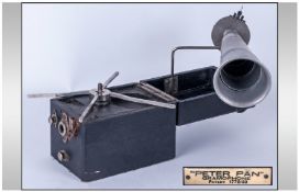 Peter Pan Portable Gramophone having an aluminum telescopic horn and in a leather case. Appears