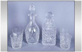 4 Crystal Cut Glass Whiskey Glasses together with two similar Decanters. All with a star cut base.(