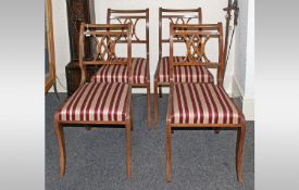 Four Regency Reproduction Dining Chairs, in stained beech, with striped upholstered seats.