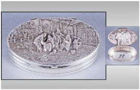 Danish Silver Oval Shaped Lidded Patchwork Box. The cover in high relief of figures playing musical