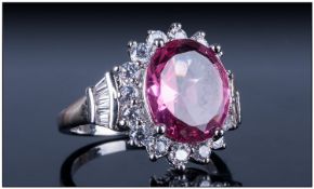 Pink Tourmaline And White Topaz Ring. Oval cut Tourmaline Surrounded by white faceted Topaz.