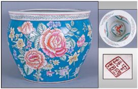 A Reproduction Chinese Planter decorated with floral decoration. 12 inches in diameter.