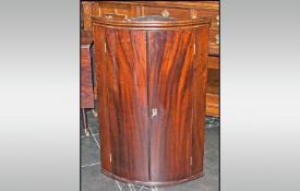 Georgian Mahogany Bow Fronted Corner Cupboard, circa 1800, with a moulded top. 41`` in height 47``