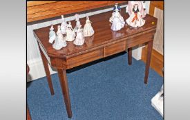 A Late Georgian Fold Over Top Mahogany Tea Table on square tapering legs & shaped corners to the