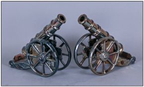 Pair Of 1920`s/1930`s Enamelled Iron Models Of Cannons. Height 9 inches, length 11 inches.