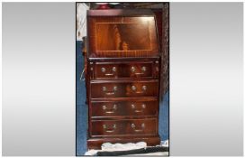 Reproduction Mahogany Inlaid Bureau Of Small Proportions. fall fronted fitted interior below four