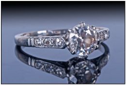 WITHDRAWN     A Platinum Set Single Stone Diamond Ring with six small diamonds to shoulders. est