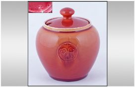 William Moorcroft Signed Small Pink/Red Flamminian Ware Lidded Sugar Pot, with foliate roundels.