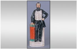 A Nineteenth Century Staffordshire Flatback Figure of Moody, Standing upright in a black suit with