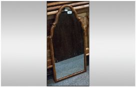 Mirror with Tapering top design. Encased in a wood like  frame. 29 inches high, 15 inches at