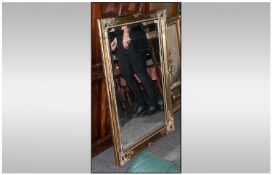 A Traditional Shaped Rococo Style Gilded Mirror, 20 by 42 inches. Bevelled glass.