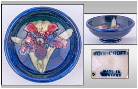 Moorcroft Small Footed Bowl, "Orchids" pattern on blue ground. Circa 1970s. Diameter 4.5 inches,