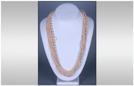 Two Multi Strand Necklaces. One in Coloured Beads, The Other Cream.