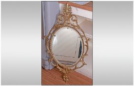 Oval Gilt Framed Mirror With Elaborate Decorative Frame, in the Rococo style. Bevelled Glass. 38" in