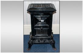 A Cast Iron Black Enamelled Wood Burning Stove, probably French or German. Circa 1900. With a lift