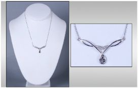 9ct White Gold Diamond Pendant, Set with black and white diamond chips. Suspended on a 9ct white