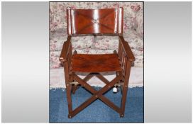 A Contemporary Folding Leather Clad Travelling Arm Chair. With brass studded screws.