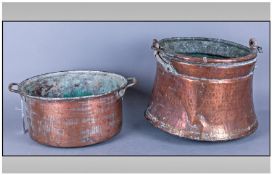Two Antique Beaten Copper Pots one with swing handles & the other with brass side handles.