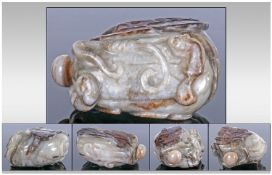 A Chinese Green Jade Melon Shaped Snuff Bottle And Stopper, with Russet inclusions, carved to the