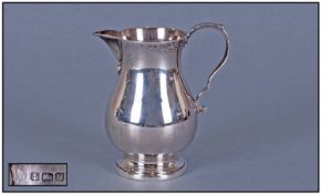 A Small Helmet Shaped 1960s Cream Jug, with scroll handle. Hallmark Birmingham 1969. 3 ozs, 2 grams.