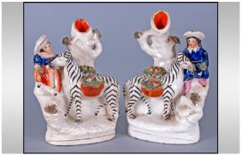 Staffordshire Pair Of Mid 19th Century Figural Spill Vases, figures and zebras with basket of