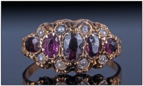Victorian 15ct Gold Dress Ring, set with a central row of graduating oval garnets with small pearl