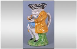 Staffordshire Late 18thC 'Snuff Taker' Toby Jug, brightly but simply coloured with yellow coat, pale