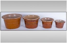 Four Graduated Stoneware Pots, the tallest 7 inches.
