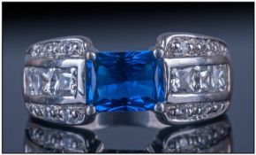 14ct White Gold Diamond Dress Ring, set with a central emerald cut blue stone between 6 channel
