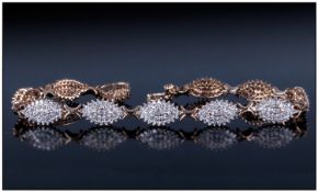 9ct Gold Diamond Bracelet, each link set with clusters of small round cut diamonds. Fully