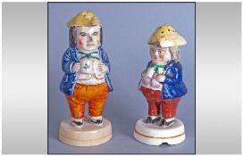 Two Staffordshire Figural Casters or Sanders, each in the style of the 'Foaming Ale' Toby, but in