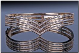 A Gold Diamond Set Bangle. The Bangle Consists of 3 Rows Diamonds (Approximately 190 Diamonds) all