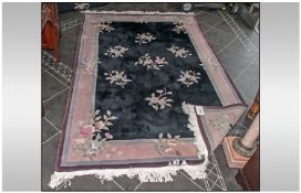 Quality Large 100% Wool Pile Rug, predominantly black with pink border. 2.74m by 1.83m.