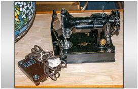 A Boxed Singer Sewing Machine, Early electric.