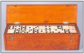 Cased Set Of Bone And Ebony Dominoes. 55 Pieces double 9s, in mahogany fitted case.