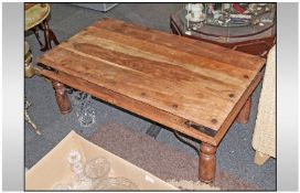 An Indian Teak Rustic Coffee Table on Baluster Type Short Legs with wrought iron supports and iron