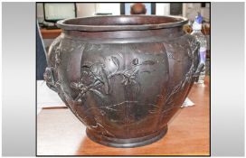A Large Japanese Bronze Planter, with a lobed shaped body, decorated with cast birds on foliage