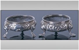 George III Pair Of Silver Salts, with embossed floral decorations raised on splayed feet. Hallmark