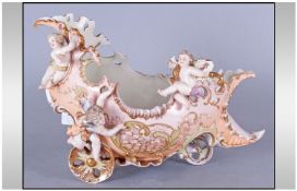 A French Late 19th Century Porcelain Vase, in the shape of a shoes on wheels, heavily gilded and