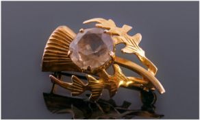 A Scottish 9ct Gold Thistle Brooch with a semi precious cut central solitaire. Makers Mark W.B.S.