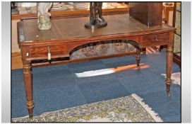 A Late Victorian Mahogany Leather Topped Partners Desk, on turned legs with brass castor feet With