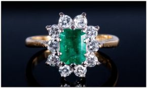 18ct Gold Cluster Ring Set With A Central Emerald Surrounded By 10 Round Modern Brilliant Cut