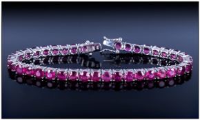 Ruby Tennis Bracelet, 25cts of round cut, rich red rubies set in a continuous line and fastened