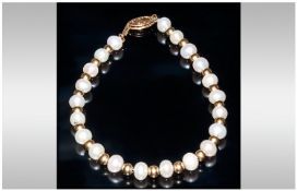 A Fine Cultured Pearl Bracelet with Gold Spacers and 18ct Gold Clap, Marked 750. 7 Inches In